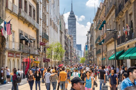 Bustling City Street with Pedestrians and Skyscraper in the Background Madero Street, one of the most famous pedestrian streets in Mexico City