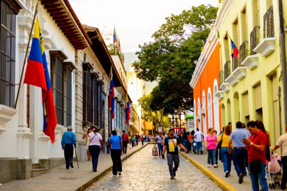 Pedestrians Walking on Colorful Street in Caracas People stroll through cobblestone streets in the city center of Caracas
