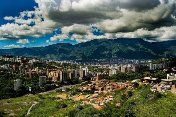 Caracas Cityscape with Mountains and Clouds Landscape of Caracas, situated in a valley surrounded by the Avila mountain range