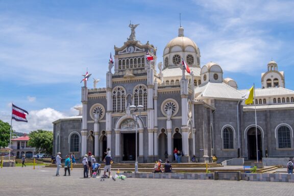 Costa Rican flags fly outside of the Basilica of OUr Lady of the Angels in the city of Cartago, Costa Rica. 