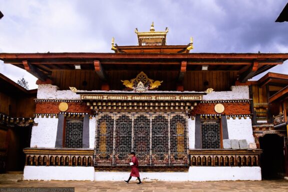 Person Walking in Front of Traditional Bhutanese Temple Changangkha Lhakhang, a 12th-century temple overlooking Thimphu