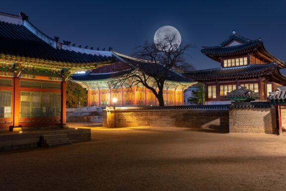 Deoksugung Palace at Night with Full Moon Deoksugung Palace, famous for its elegant stone-wall road