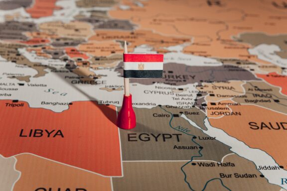 A pin with the Egyptian flag marking Egypt's location on a map.