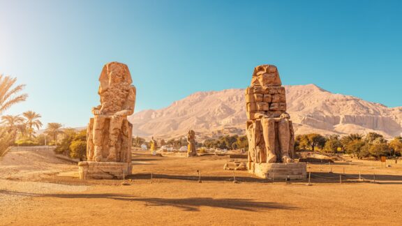 A view of the Colossi of Memnon on a sunny day near Luxor, Egypt.