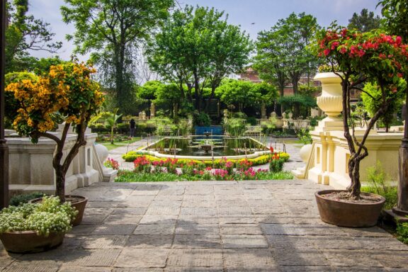 Sunny Garden Pathway with Blooming Flowers and Central Fountain The Neo-Classical Garden of Dreams