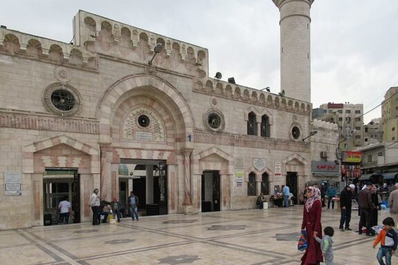 Facade of the Grand Husseini Mosque with People Gathering Outside Grand Husseini Mosque, founded in 1924