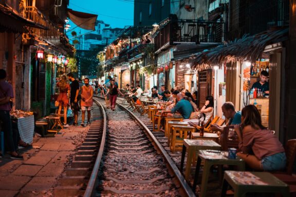 Evening Bustle in Hanoi Old Quarter Street Train street filled with shops, restaurants, and cafes in Hanoi's Old Quarter