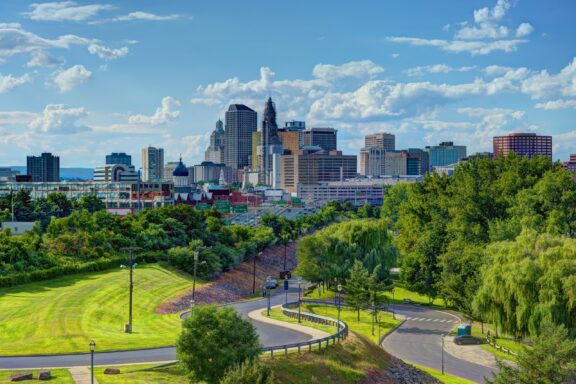 The skyline of Hartford, Connecticut can be seen from a distance on a mostly clear day. 