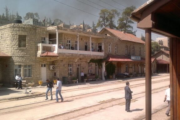 Old Railway Station Building with People on Platform Hejaz Railway Station, part of the Ottoman Empire's ambitious railway project connecting Damascus to Medina