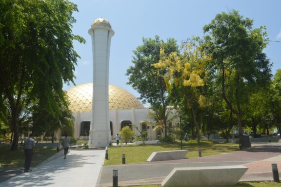 Dome and Minaret of Mosque in Sunny Park Setting Hulhumale Mosque, noted for its modern architecture and serves the community’s growing population