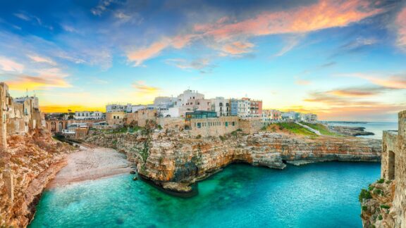 The Adriatic coastline at Polignano a Mare in Southern Italy at sunset. 