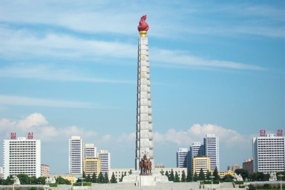 Juche Tower in Pyongyang against Blue Sky Juche Tower, dedicated to the philosophy of Juche