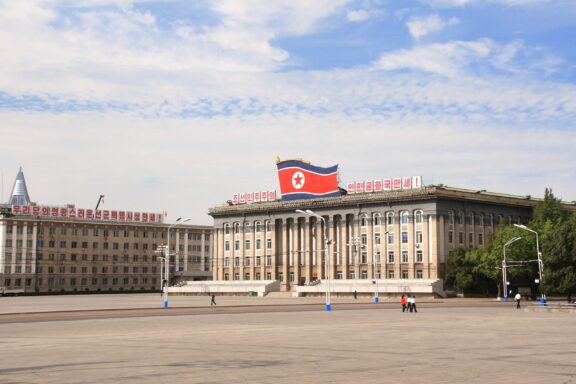Kim Il-sung Square with Flag and Buildings Kim Il-sung Square, a central gathering place in Pyongyang that hosts parades, rallies, and public gatherings