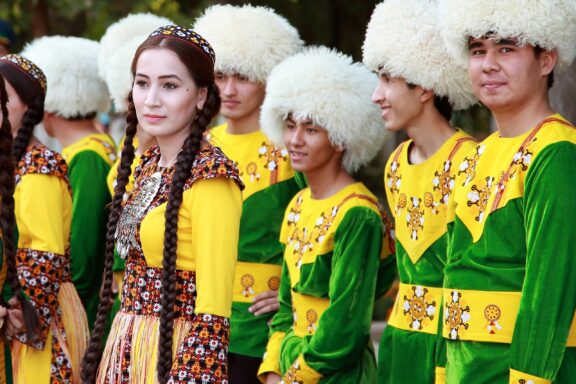 A group of dancers in traditional clothing at the Kurban-Bairam Festival