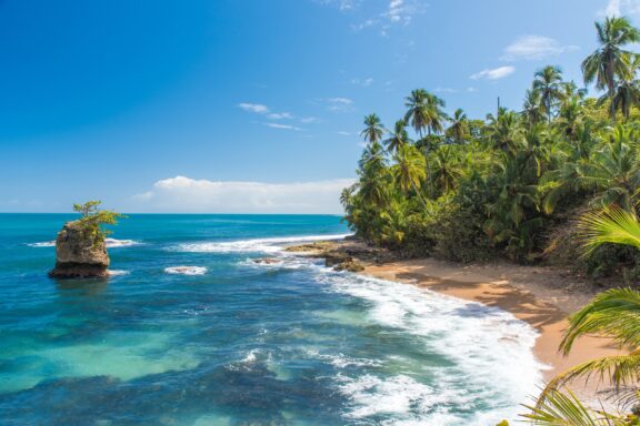 Blue waters line the sandy shore of Manzanillo Beach near Puerto Viejo in southern Costa Rica.