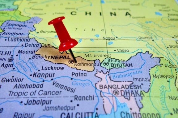 Pushpin marking the location of Kathmandu, Nepal, and its neighboring countries and capitals