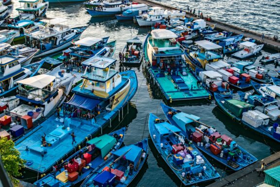 Boats Docked at Busy Maldives Port A crowd of boats at the Malé Port, a hub for fishing and trade