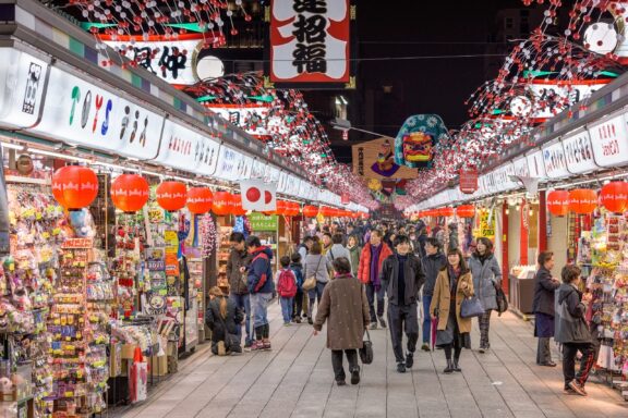 Bustling Nakamise Shopping Street with Lanterns and Crowds Pedestrians stroll through Nakamise Shopping Street
