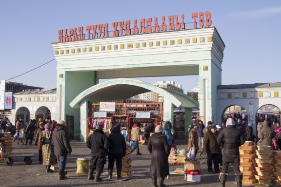 Entrance of Naran Tuul Market with People and Vendors Naran Tuul Market, also known as the "Black Market"
