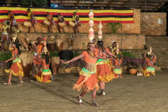 Traditional Dance Performance at Ndere Cultural Centre Dancers performing at the Ndere Cultural Centre, dressed in traditional Ugandan wear