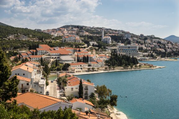 A view of houses and trees lining the sea in Neum, Bosnia.