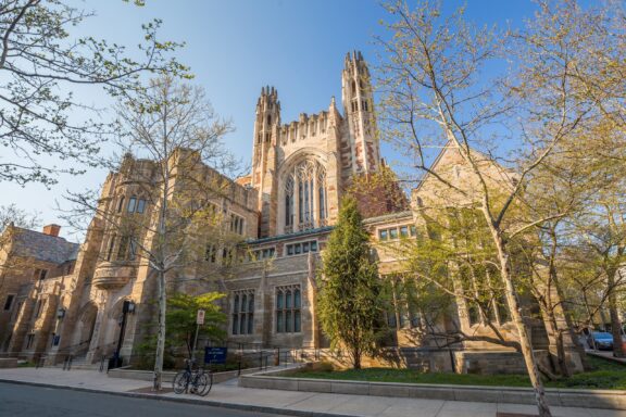 Springtime View of Yale University's Historic Gothic Architecture under a Clear Blue Sky A low-angle view of a Yale University building in New Haven, Connecticut.