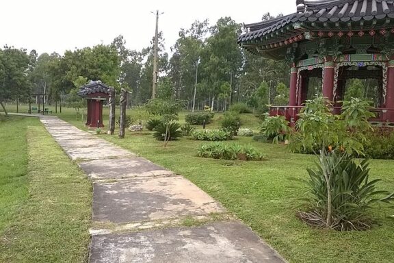 Pathway Leading to a Traditional Pavilion in a Park Ñu Guasu Park, large urban green space within the bustling city of Asuncion