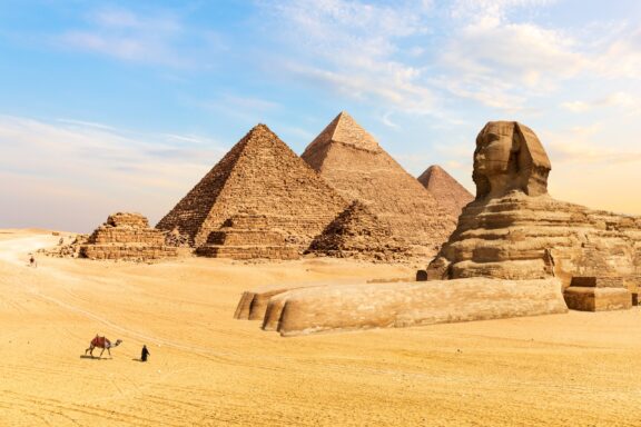 The Pyramids of Giza and the Great Sphinx in the desert of Egypt.