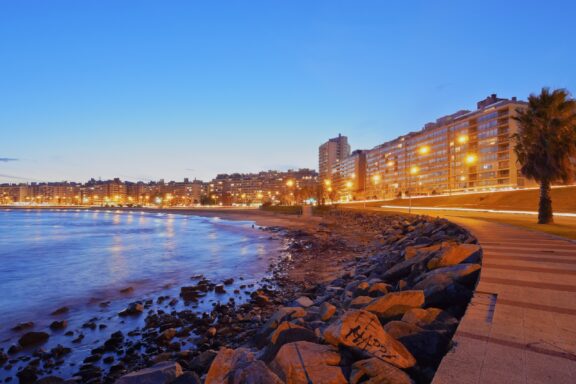 Twilight at Montevideo's Rambla with City Lights Rambla of Montevideo, a 13.7-mile popular venue for evening strolls, offers scenic coastline views