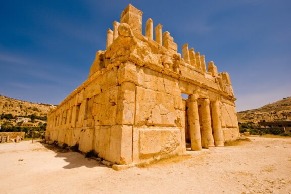 Ancient Stone Ruins Under Clear Sky The ruins of Qasr al-Abd, dating back to the 2nd century BC