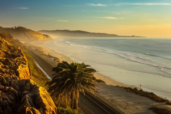 A light mist covers the Terry Pine Beach at sunset in San Diego.