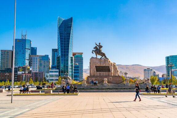 Sukhbaatar Square with Statue and Modern Buildings in Ulaanbaatar, Mongolia Sukhbaatar Square, often the venue for national celebrations and protests alike