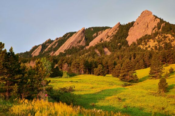 The sunrise illuminates the Flatirons outside of Boulder, Colorado.