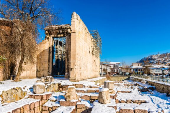 Snow-Covered Ancient Temple Ruins under Blue Sky The Temple of Augustus, built in the 2nd century BC
