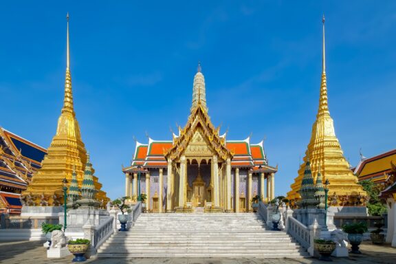 Temple of the Emerald Buddha under blue sky Wat Phra Kaew, Buddhist temple located within the grounds of the Grand Palace.