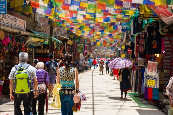 Tourists Walking in Colorful Thamel Market District Thamel Square, Kathmandu's vibrant tourist hub, known for its bustling shops, hotels, and nightlife