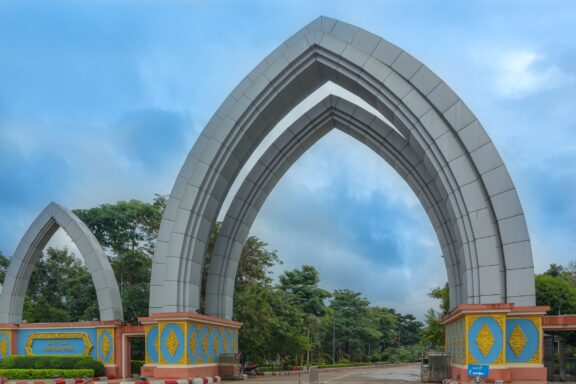 Arch-shaped Monument in a Park Water Fountain Garden, where artistry and nature intertwine