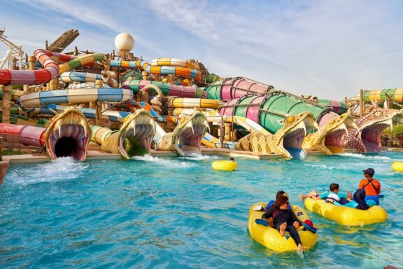 Visitors Enjoying a Water Park with Colorful Slides Slithers Slides inside the Yas Waterworld