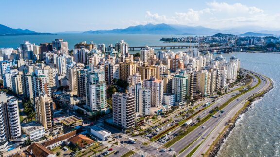 An aerial view of the city center of Florianópolis extending into the sea.