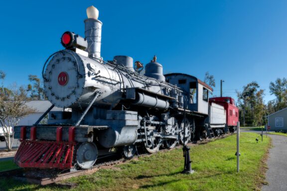 A historic steam locomotive stands in the sun in Blountstown, Florida.