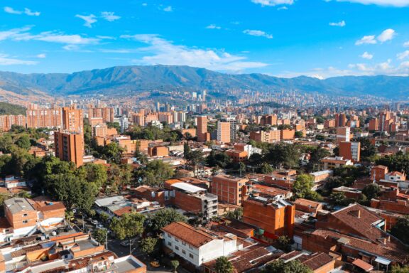 A view of neighborhoods in Medellín, Colombia extending into the distance on a sunny day. 