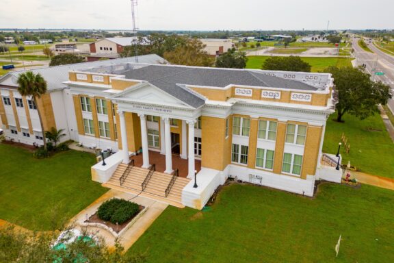 An aerial view of the white-and-yellow Glades County Courthouse in Moore Haven, Florida.