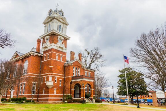 A low-angle view of the Gwinnett County Courthouse in Lawrenceville, Georgia on a cloudy day. 