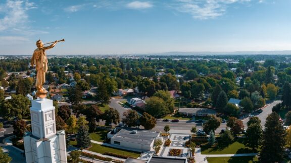 A view of the golden statue atop the Idaho Falls Temple in Bonneville County and the surrounding city. 