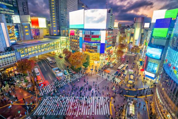 A top-down view of Shibuya Crossing in Tokyo, Japan, full of people.