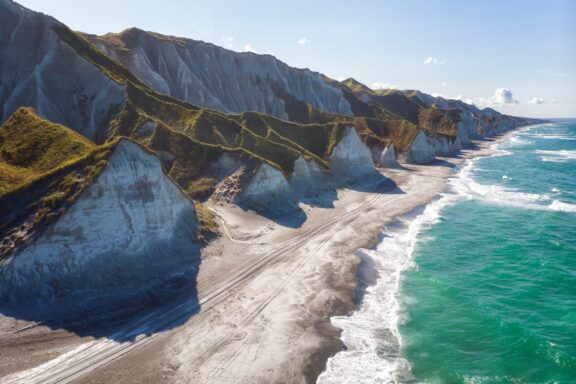 White cliffs line the shore of Iturup Island in the Kuril Archipelago.