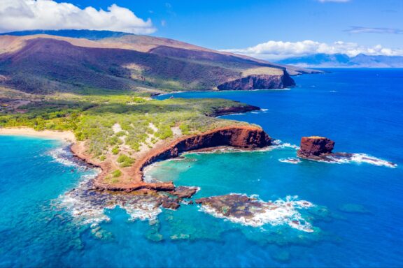 Aerial View of the Vibrant Coastline and Clear Waters of Lanai, Hawaii An aerial view of Lanai Island and the surrounding blue waters.