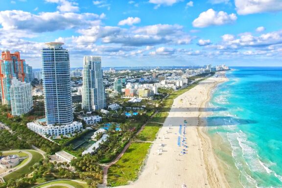 Aerial View of South Beach, Miami-Dade County, Florida with Clear Blue Waters and Skyline An aerial view of white sand and blue waters at South Beach, Miami Beach.
