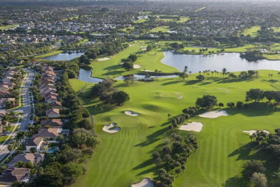 Aerial View of a Lush Golf Community with Lakes in Palm Beach An aerial view of a golf community in Palm Beach, Florida.