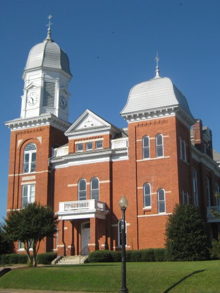 A low-angle view of the brick Taliaferro County Courthouse in Crawfordville, Georgia. 